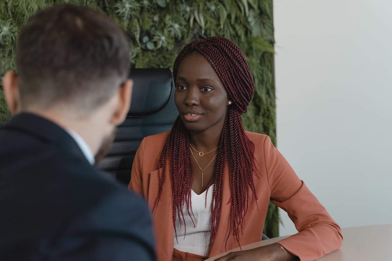 Confident businesswoman in a formal setting, engaging in a professional discussion.