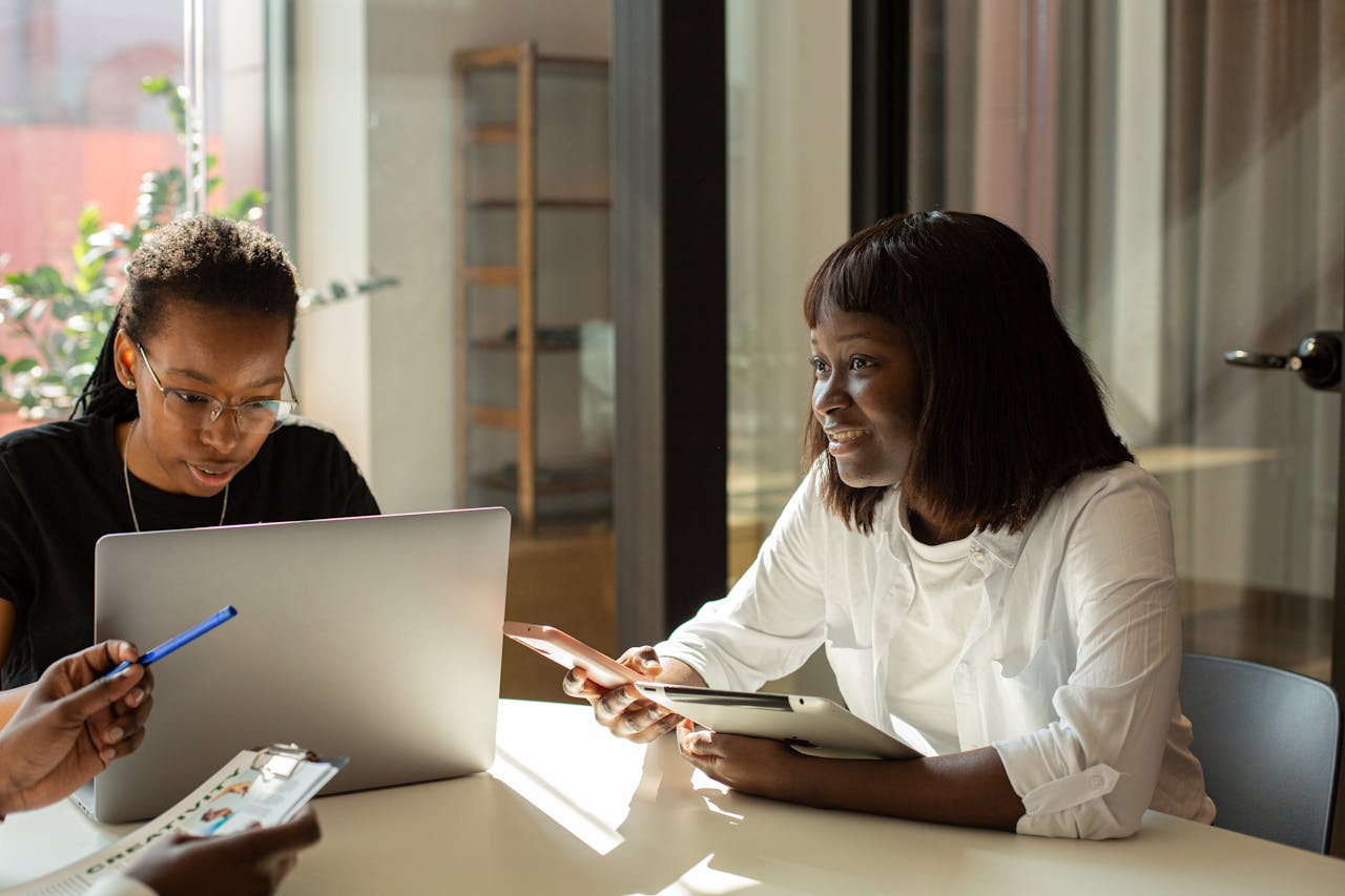 Business meeting with diverse adults collaborating in a modern office setting.